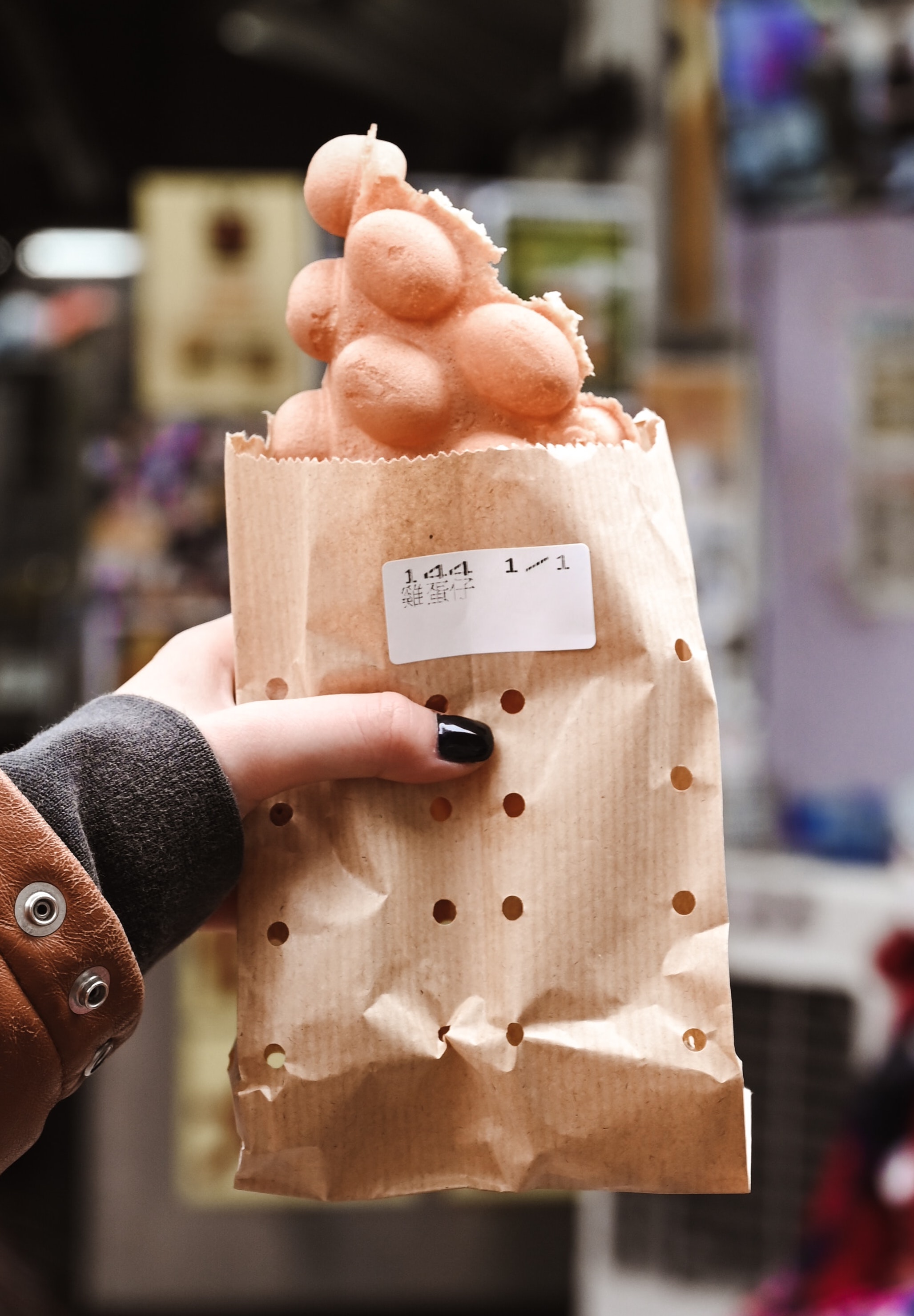 person holding egg waffle